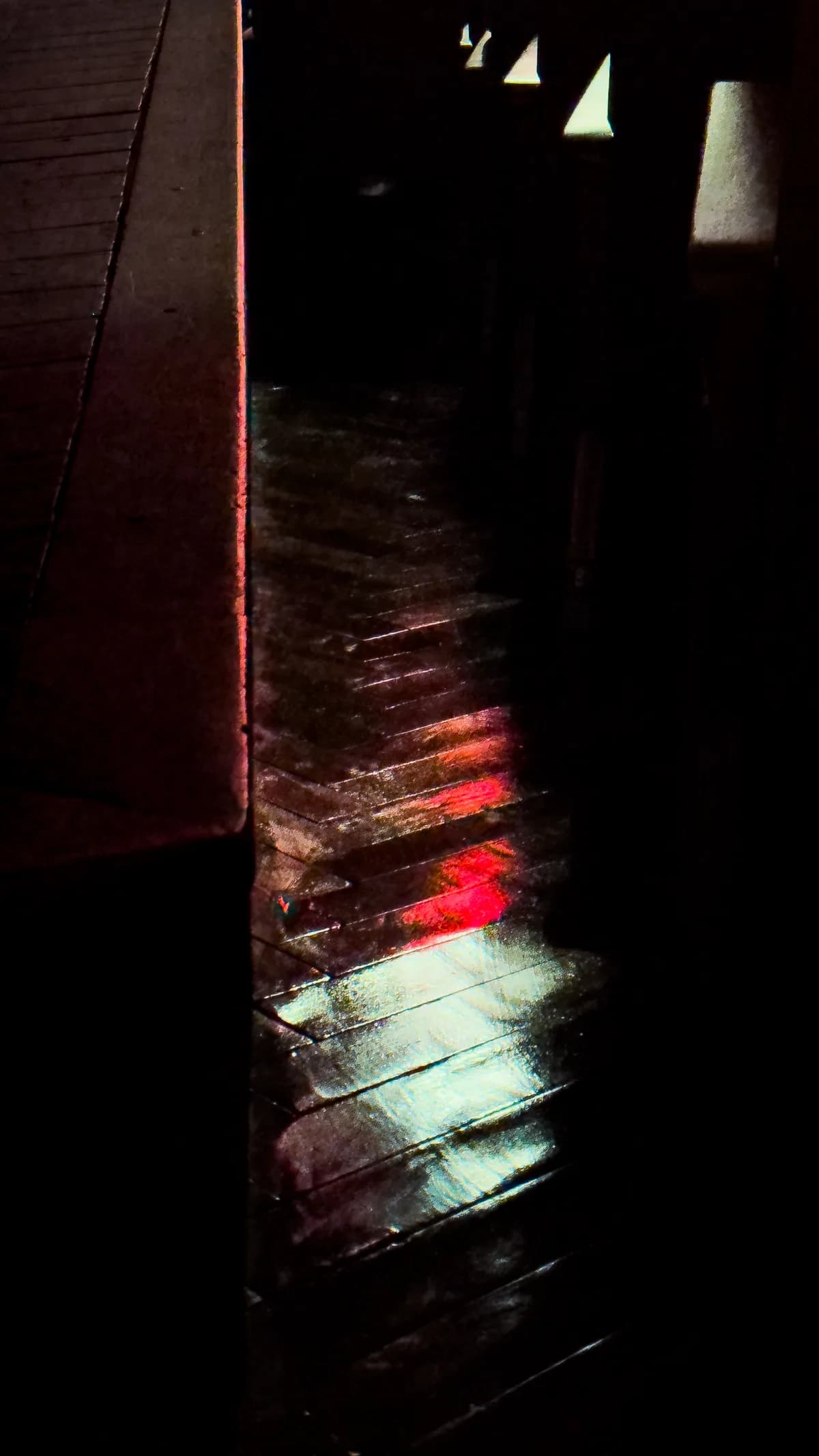Color lights reflected on wooden floor slats