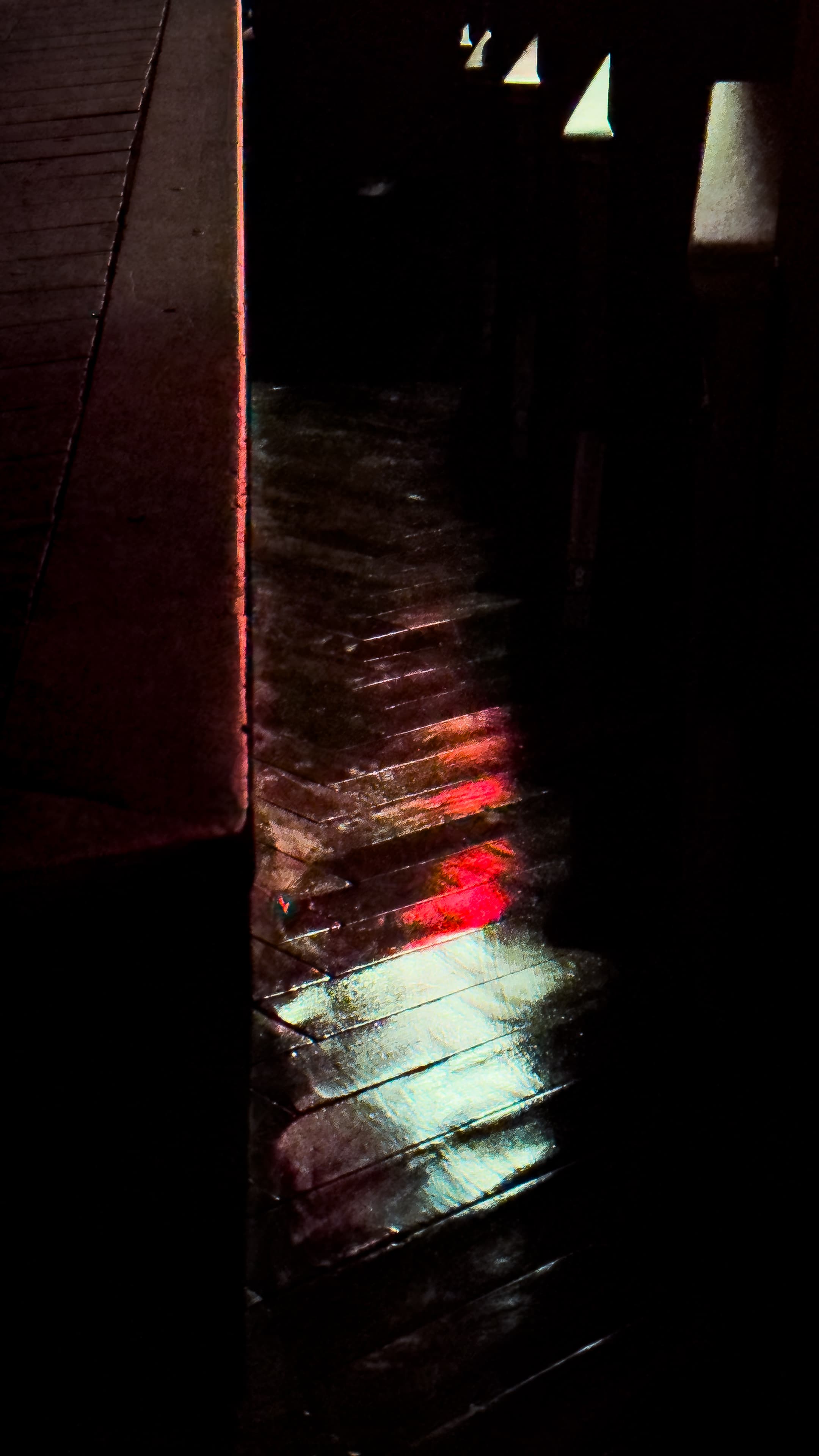 Color lights reflected on wooden floor slats